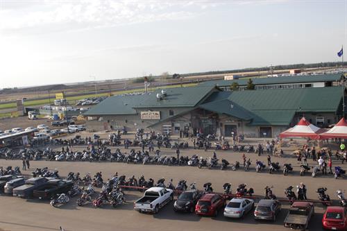 Blackjacks Roadhouse in Nisku, Alberta, with motorcycles and cars parked outside during a busy community event.